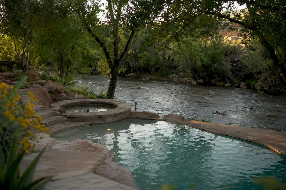 Backyard pool and river access near rental