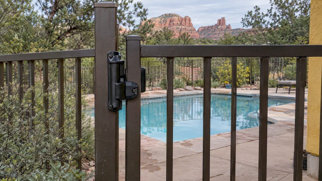 Self-latching gate beside a rental pool
